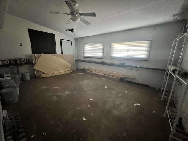 interior space featuring ceiling fan and concrete flooring