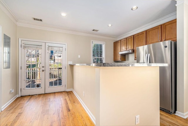 kitchen featuring stainless steel refrigerator, kitchen peninsula, french doors, and ornamental molding