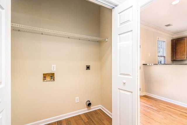 laundry room with crown molding, light hardwood / wood-style floors, washer hookup, and hookup for an electric dryer