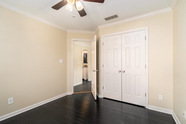 unfurnished bedroom featuring dark hardwood / wood-style flooring, ceiling fan, a closet, and crown molding