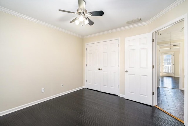 unfurnished bedroom featuring ceiling fan, a closet, dark hardwood / wood-style floors, and ornamental molding