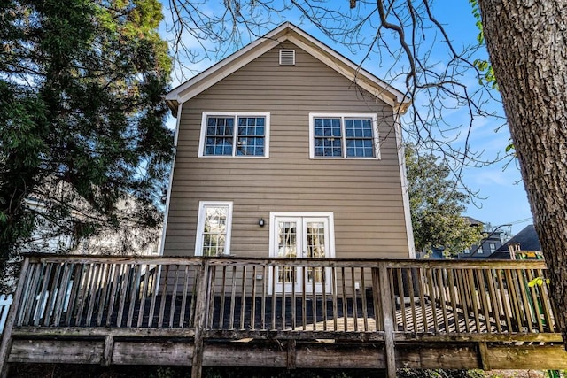 rear view of property with a wooden deck