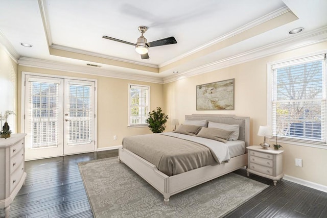 bedroom featuring access to exterior, dark hardwood / wood-style flooring, a raised ceiling, and ceiling fan