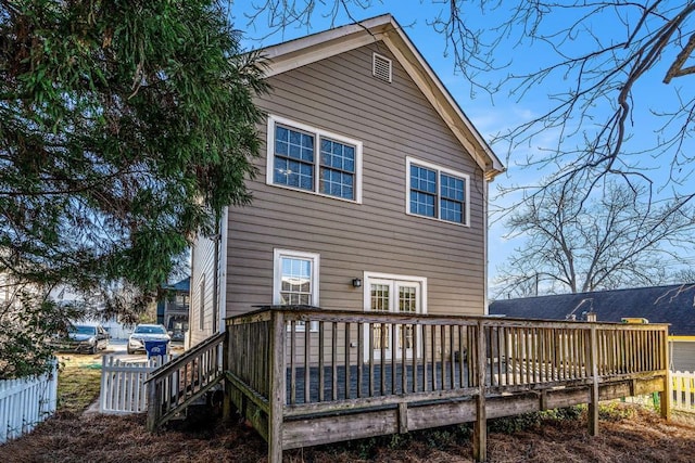 rear view of property featuring a deck