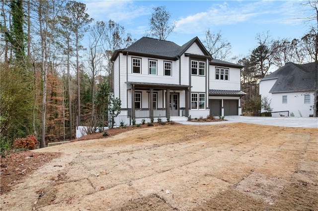 view of front of home featuring a porch and a garage