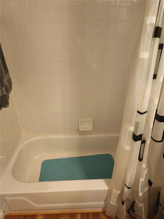 1075 Peachtree Walk NE Unit 506, Atlanta, GA 30309 - full bath featuring shower / bathtub combination with curtain