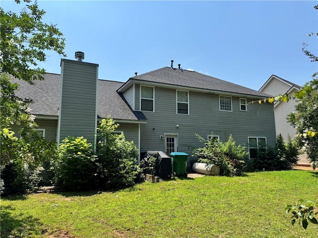 3140 Ridge Hill Pkwy, Douglasville, GA 30135 - rear view of house with a yard, roof with shingles, and a chimney
