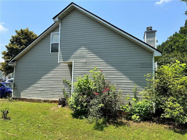 3140 Ridge Hill Pkwy, Douglasville, GA 30135 - view of side of home featuring a lawn and a chimney
