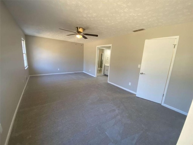 empty room featuring ceiling fan and a textured ceiling