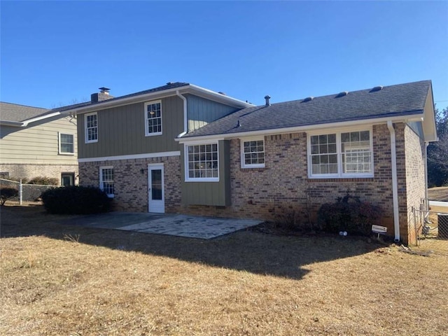 back of house featuring a yard and a patio