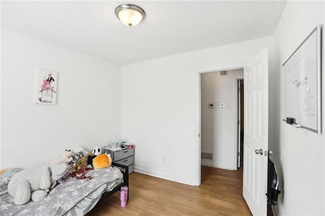 bedroom with light hardwood / wood-style flooring