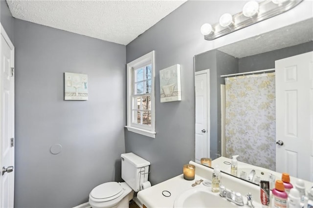 bathroom with toilet and a textured ceiling