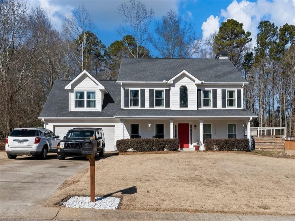 view of front of home featuring a porch and a garage