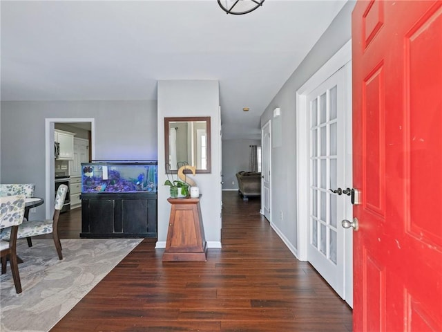 foyer entrance featuring dark wood-type flooring and french doors