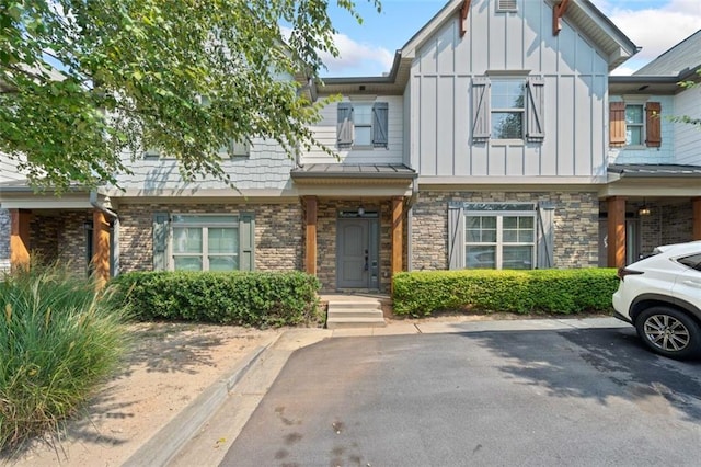 townhome / multi-family property with board and batten siding and stone siding