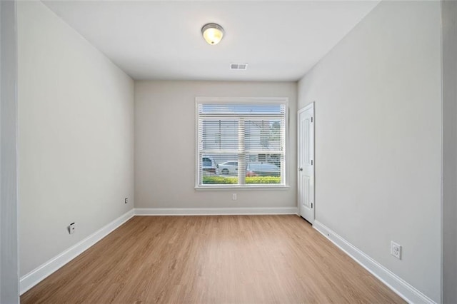 spare room with visible vents, baseboards, and light wood-style flooring