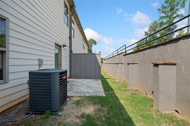 view of yard with cooling unit, a patio area, and fence