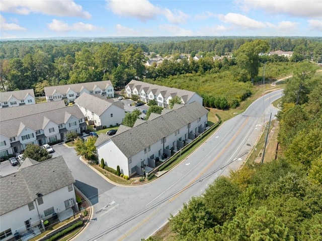 birds eye view of property with a wooded view and a residential view