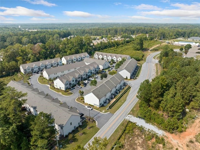 aerial view featuring a residential view and a wooded view