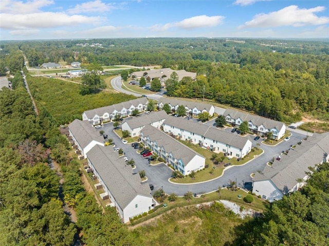 birds eye view of property with a view of trees and a residential view