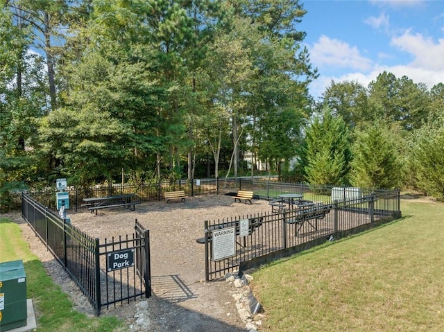 view of home's community with fence and a lawn