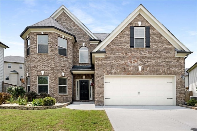 829 Overlook Path Ln, Lawrenceville, GA 30045 - view of front of house with driveway, a front yard, a garage, and brick siding