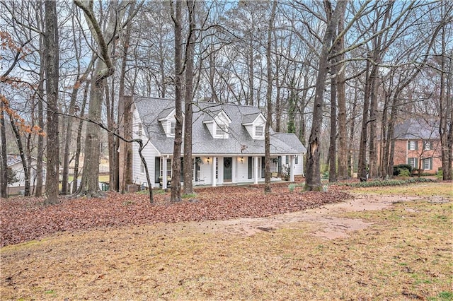 cape cod house featuring a porch