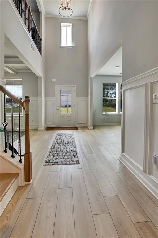 297 Delta Dr, Mcdonough, GA 30252 - entryway featuring a towering ceiling, stairway, a chandelier, wood finished floors, and a decorative wall