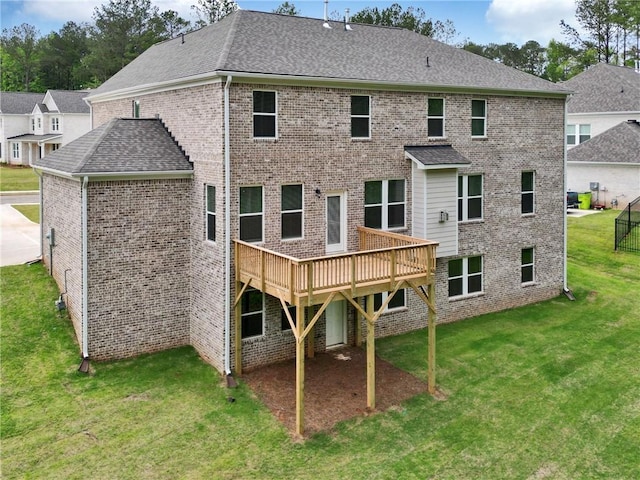 297 Delta Dr, Mcdonough, GA 30252 - back of property featuring a yard, a deck, brick siding, and roof with shingles