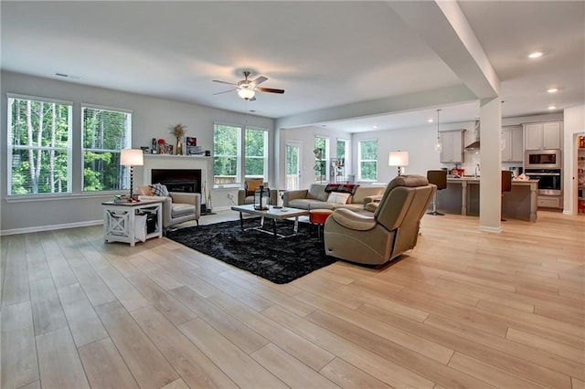 297 Delta Dr, Mcdonough, GA 30252 - living room with a ceiling fan, light wood finished floors, a fireplace, baseboards, and recessed lighting