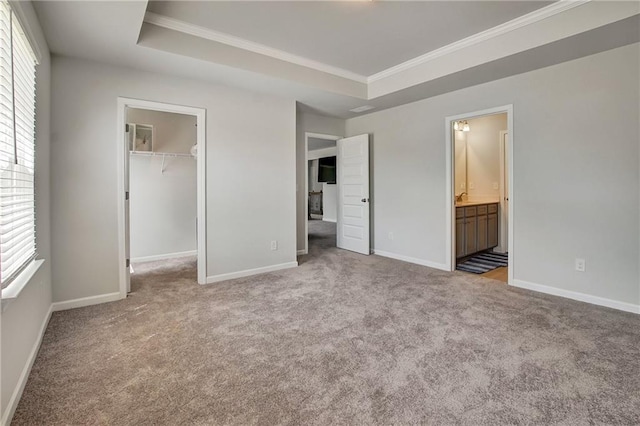 297 Delta Dr, Mcdonough, GA 30252 - unfurnished bedroom with crown molding, carpet flooring, baseboards, a walk in closet, and a closet