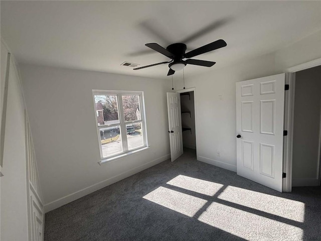 unfurnished bedroom featuring visible vents, baseboards, ceiling fan, and carpet flooring