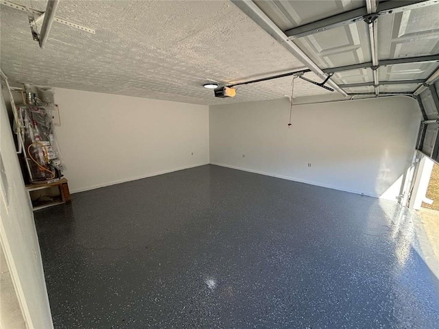 garage with baseboards and a garage door opener