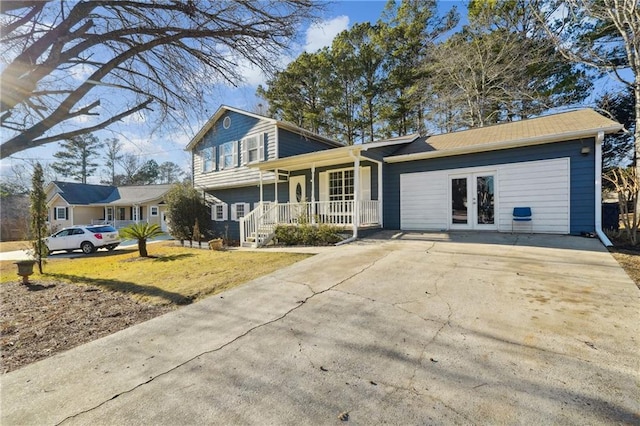 view of front of home with a porch, a front yard, and french doors