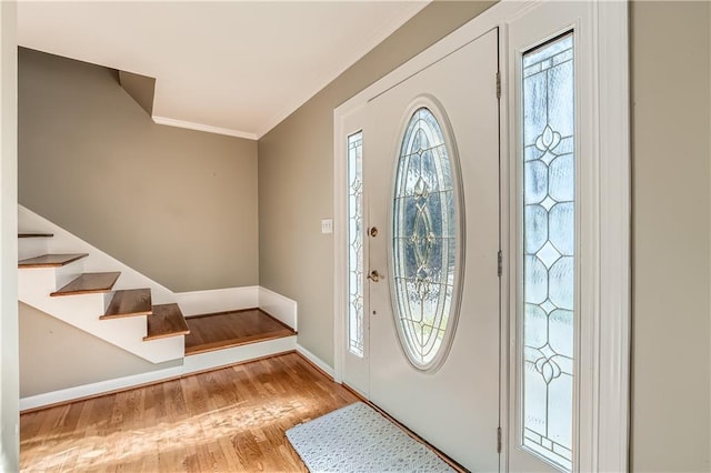 foyer featuring light hardwood / wood-style floors and crown molding