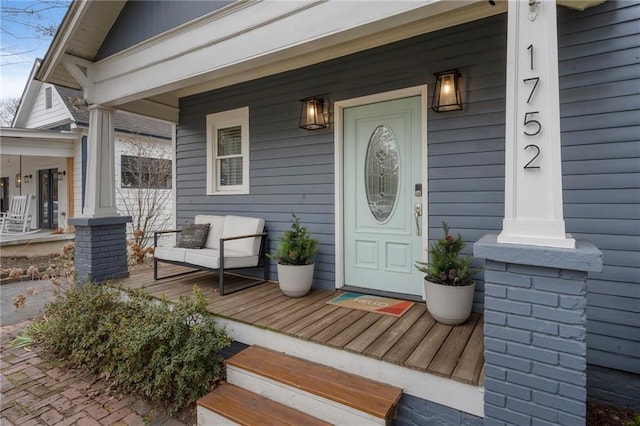 view of exterior entry featuring covered porch