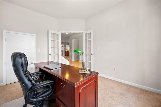 office area featuring light colored carpet, baseboards, and french doors
