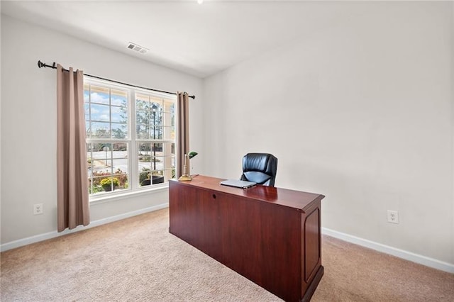 carpeted office with visible vents and baseboards