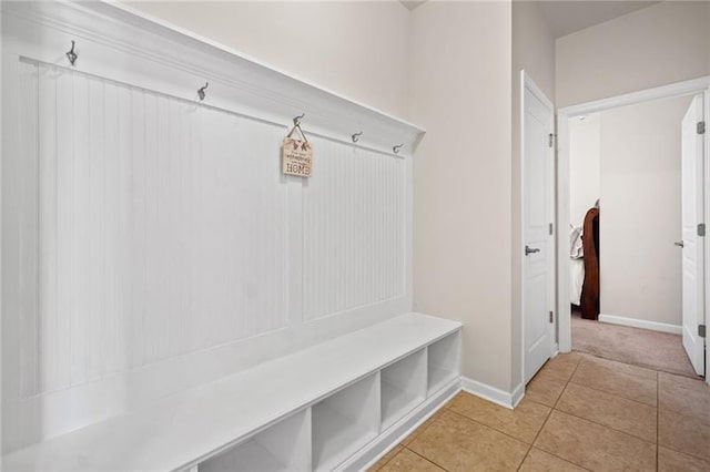 mudroom with baseboards and light tile patterned floors