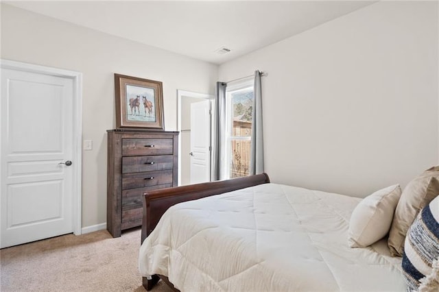 carpeted bedroom featuring baseboards and visible vents