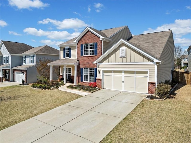 traditional-style home with driveway, brick siding, a front yard, and a garage