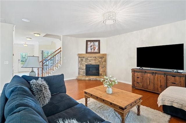 living room with baseboards, wood finished floors, and stairs