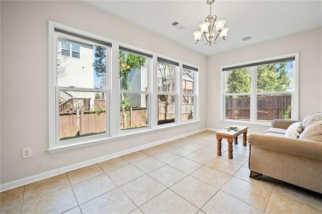 sunroom / solarium with an inviting chandelier and visible vents