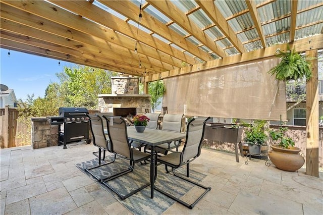 view of patio / terrace with a grill, a pergola, fence, an outdoor stone fireplace, and outdoor dining space