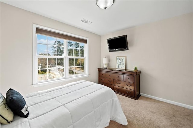 bedroom featuring carpet floors, visible vents, and baseboards