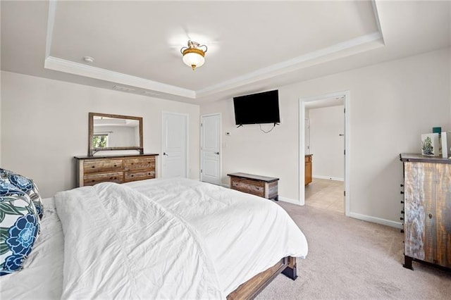 bedroom featuring light carpet, baseboards, and a raised ceiling