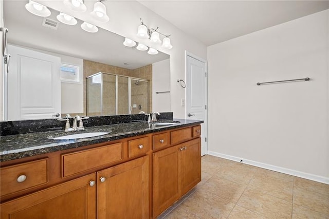 full bath with a shower stall, visible vents, a sink, and double vanity