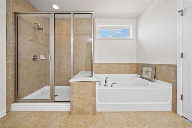 bathroom featuring a bath and a shower stall