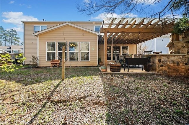 rear view of property with a pergola and a patio