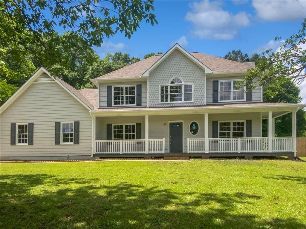 225 Woodfield Ct, Mcdonough, GA 30253 - colonial-style house featuring covered porch, a front yard, and a shingled roof